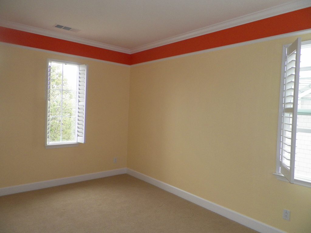 child's room with yellow and red paint including white crown