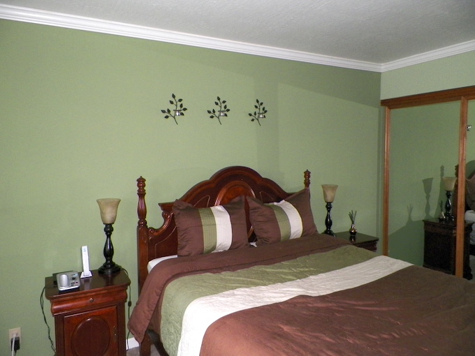 Bedroom with dark sage green paint on wall