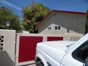 exterior home with red gate after paint